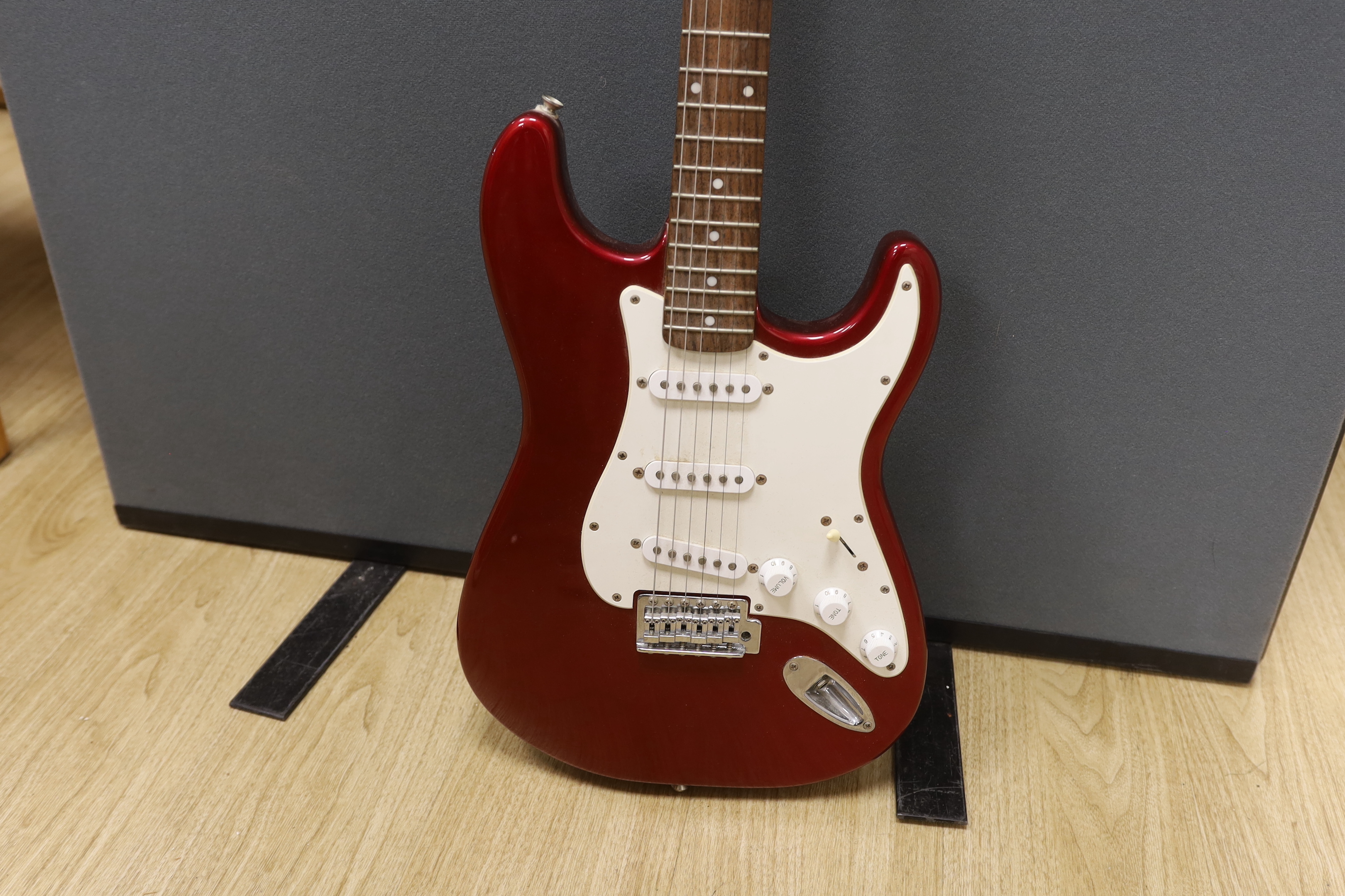 A Fender Squier Strat electric guitar with a soft case